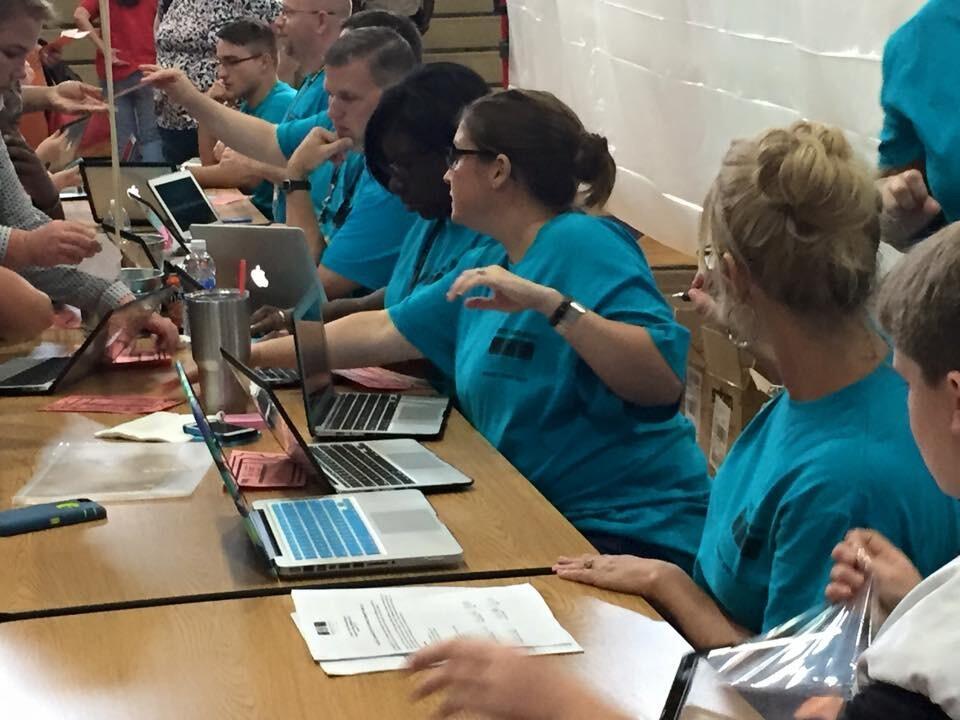 Technology Staff enrolling MacBooks